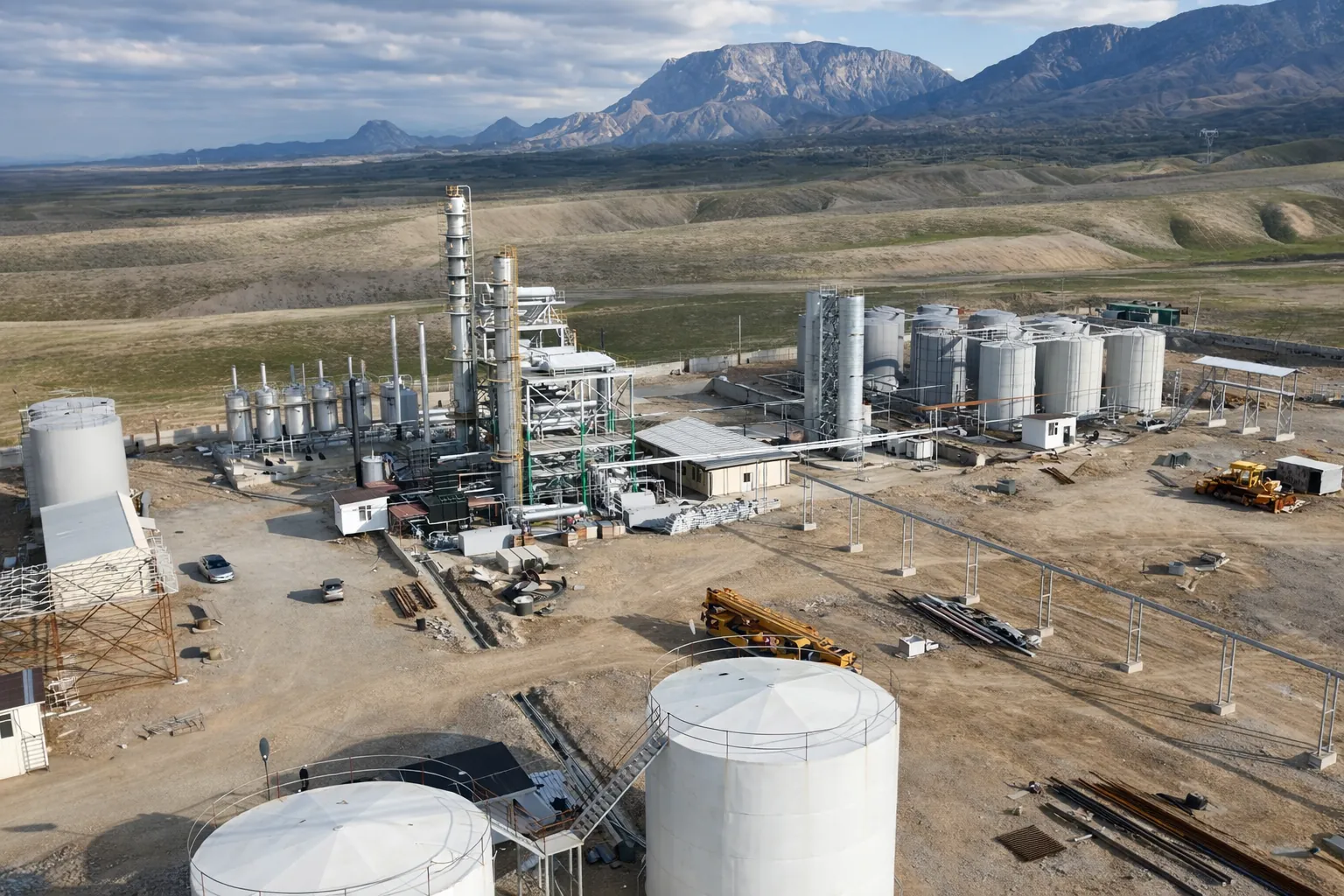 Refinery with dramatic mountain backdrop